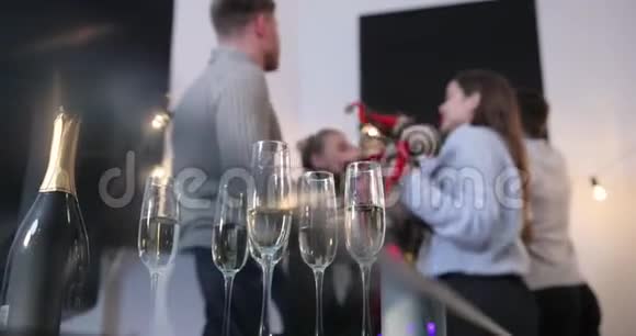 新年庆典人们在后台跳舞而镜头则聚焦在香槟长笛上视频的预览图