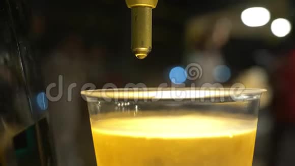 特写镜头男人把啤酒倒进塑料杯里街头美食视频的预览图