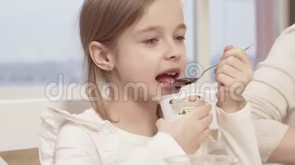 小女孩在一次家庭晚餐中吃了一份美味的巧克力慕斯视频的预览图