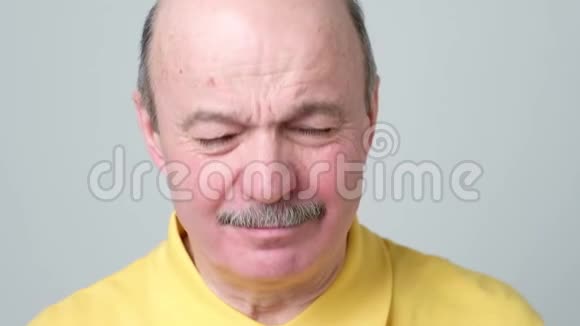 一个压力很大的老人用双手合上他的脸视频的预览图