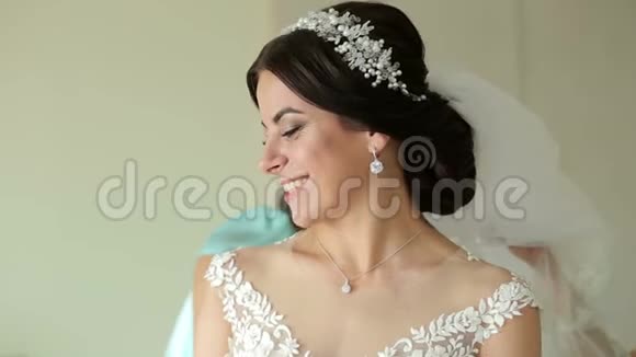 穿着白色裙子的新娘伴娘帮新娘系好婚纱视频的预览图