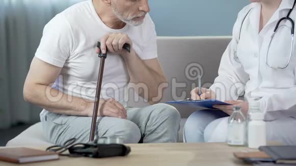 老人坐在沙发上与医生医疗和疾病交谈视频的预览图