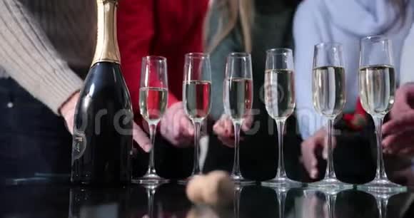 新年庆典人们在后台跳舞而镜头则聚焦在香槟长笛上视频的预览图
