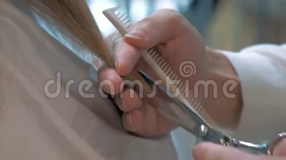 理发师的特写慢镜头剪年轻女性的头发视频的预览图