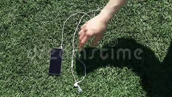 男人把他的智能手机从草坪上拿下来视频的预览图