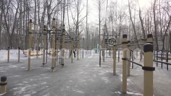 冬季公园运动场男子健美运动员训练视频的预览图