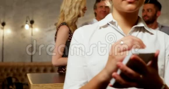 女服务员微笑着朋友在酒吧喝酒视频的预览图