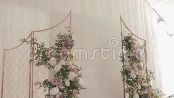 餐厅婚礼装饰金色的婚礼祭坛装饰着绿色植物和白色玫瑰的花环视频的预览图