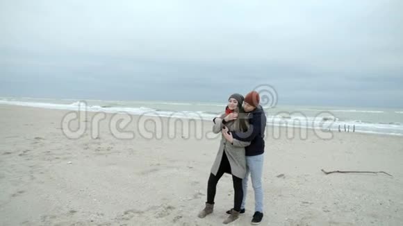 美丽的夫妻正和一个女儿和一只狗在海滩上拥抱视频的预览图