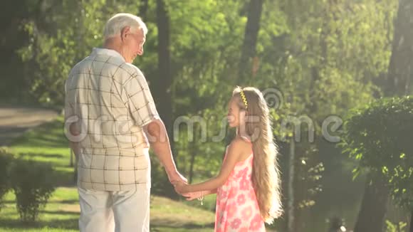 爷爷在公园里和孙女说话视频的预览图