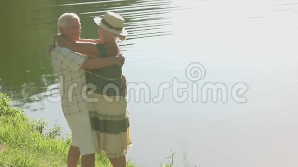 老夫妇在河边拥抱视频的预览图