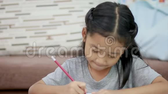 亚洲小女孩做作业带着复印空间作文开心地笑视频的预览图