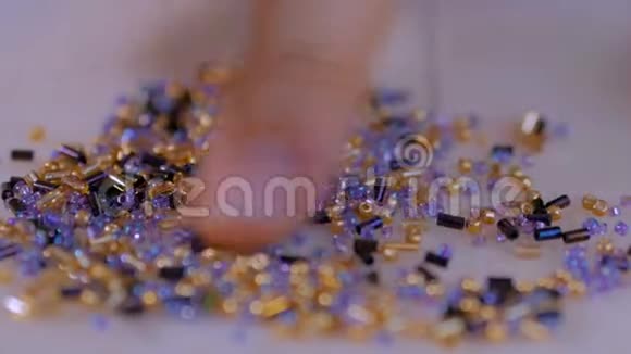 女人的手整理出五颜六色的珠子视频的预览图