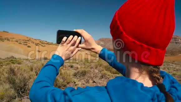 活跃的徒步旅行者女性徒步旅行在Teide国家公园并在智能手机上制作照片景观慢动作高加索人视频的预览图