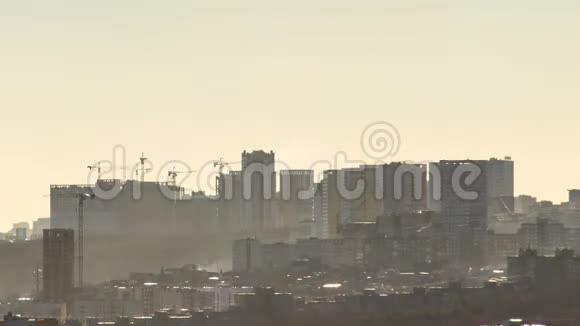 新建小区施工吊车在一座高山的边缘建造新城市晴朗的雾天视频的预览图
