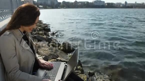 有笔记本电脑的女商人坐在沙滩上视频的预览图