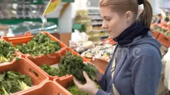 美丽迷人的年轻女子在超市挑选新鲜的绿色植物健康的饮食观念视频的预览图