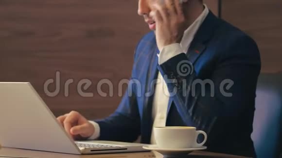 企业家用智能手机打电话用笔记本做办公室工作视频的预览图