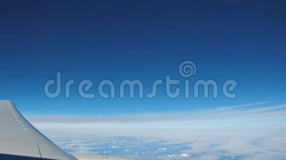 飞机视图窗口概念窗外的飞机可以看到引擎和机翼在云和天空蓝色或蔚蓝的天空在陆地上视频的预览图