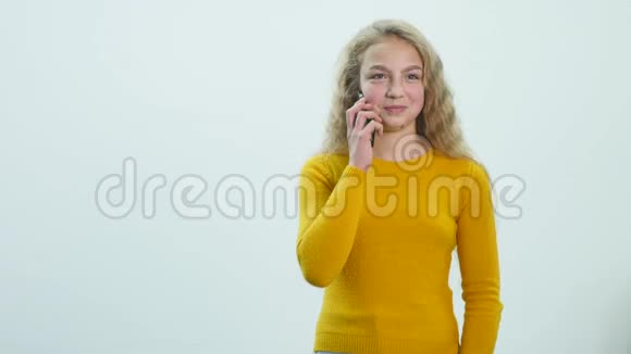 漂亮的少女正在用手机说话微笑着视频的预览图