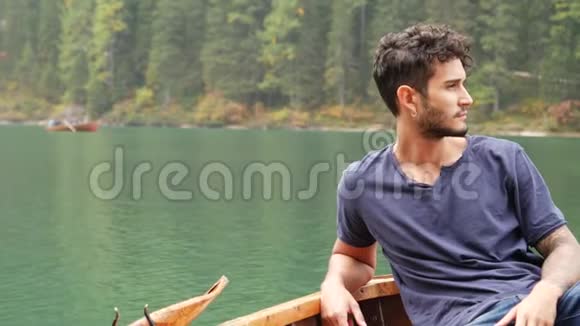 年轻人在湖边的船上放松视频的预览图