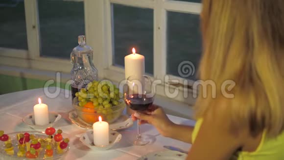 女人在餐厅用餐一张有罐头和水果的桌子喝葡萄酒视频的预览图