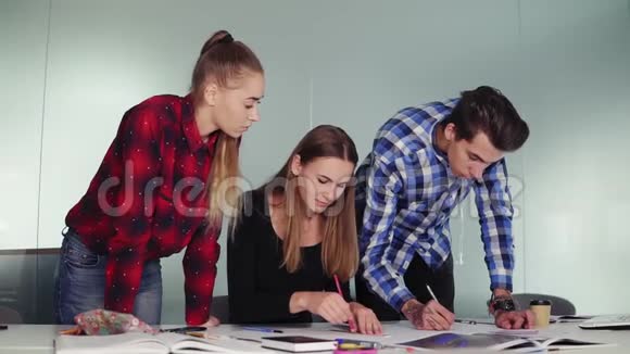 室内设计师小组在办公室一起工作年轻的嬉皮士站在旁边画素描视频的预览图