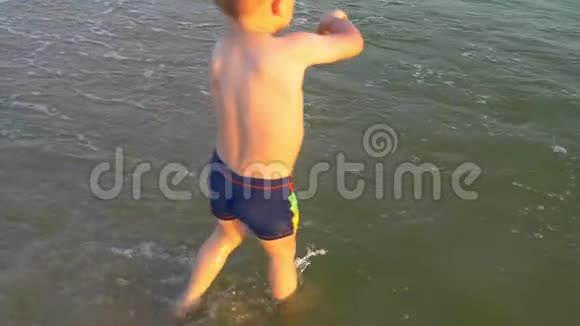 孩子在海上奔跑海浪溅起他的双脚视频的预览图