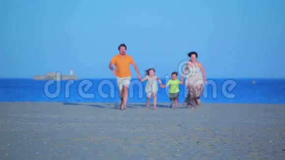 一家人在海滩上奔向大海视频的预览图
