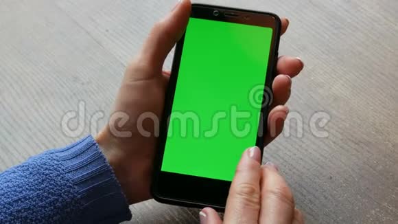 黑色智能手机上的彩色钥匙或绿色屏幕女性手中有一张木桌上精心修剪的指甲视频的预览图