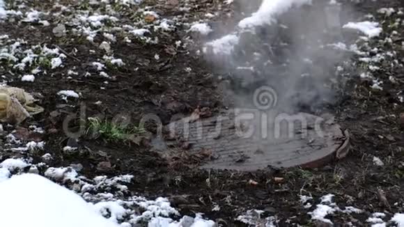 蒸汽是从卫生下水道覆盖在雪事故融化的雪特写镜头视频的预览图