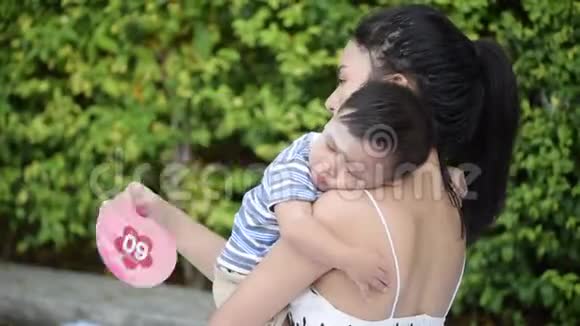 亚洲单身母亲在花园里和小儿子玩耍视频的预览图
