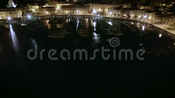 帆船港和沿海城镇4k俯仰夜空无人机镜头视频的预览图