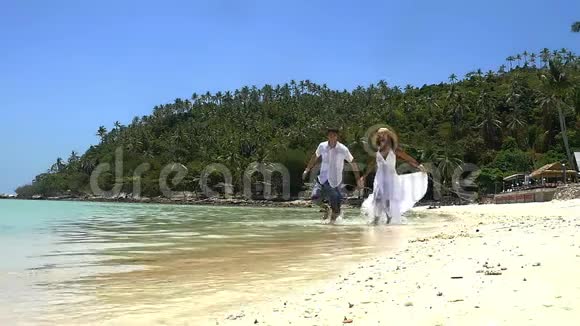 海滩暑假夫妇在假期跑步快乐的海滩度假夫妇在旅行中玩得开心视频的预览图