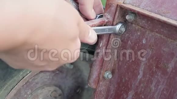 用喇叭钥匙清洁双手用生锈的旧手推车拧紧螺母视频的预览图