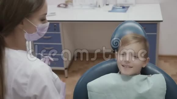 牙医用角探头和镜子检查小男孩的牙齿状况视频的预览图