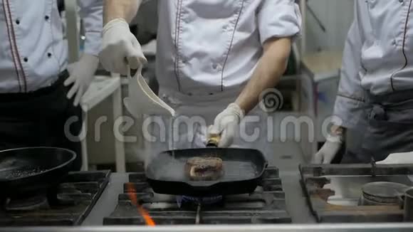 厨师在餐厅厨房的烤盘里煮牛肉牛排视频的预览图