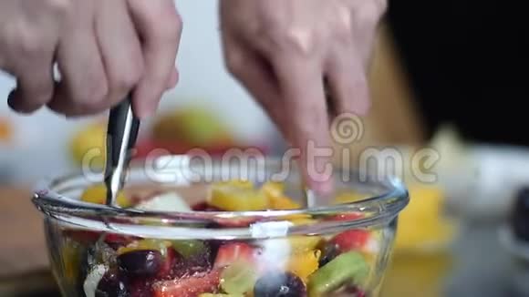 把水果沙拉拌在玻璃碗里视频的预览图