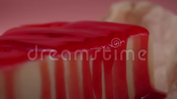 自制芝士蛋糕的特写上面覆盖着粉红色背景的浆果果酱框架美味的甜点视频的预览图