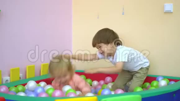 快乐的白种人幼儿在多种颜色的球池中欢笑和玩耍学前教育视频的预览图