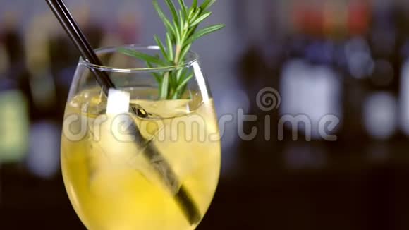 酒精鸡尾酒与起泡葡萄酒冰和酒柠檬和迷迭香在酒杯在酒吧柜台特写视频的预览图