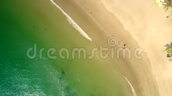 蔚蓝的海浪冲刷着金色的海滩视频的预览图