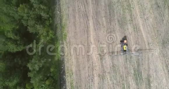 在森林收获的土地上驾驶空中观景拖拉机视频的预览图