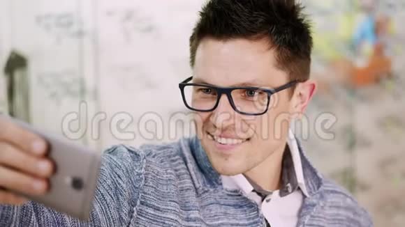 戴眼镜眼镜的英俊青年在光学商店光学光学零售商店眼镜店自拍视频的预览图