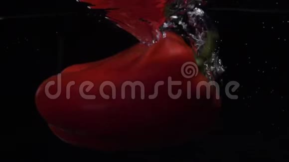 红铃椒落水慢动作黑色背景食物录像视频的预览图