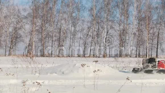 穿着冬天衣服的人在迷你雪车上克服大雪跳过漂流视频的预览图