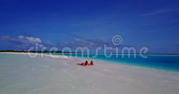 V085112年轻人浪漫情侣在白色沙滩上享受无人机空中飞行的日光浴视频的预览图