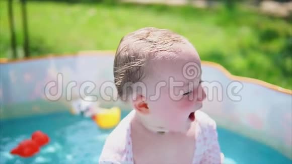 快乐的女婴拥有美好的夏日和室外游泳池视频的预览图