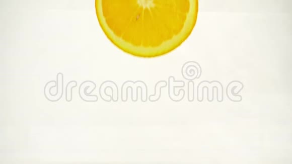 鲜嫩多汁的橙色切片溅起水花气泡落入水中慢动作特写视频的预览图