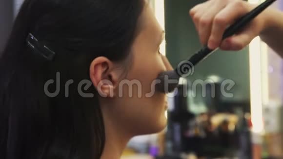 化妆师用画笔在模特脸上化妆的过程视频的预览图